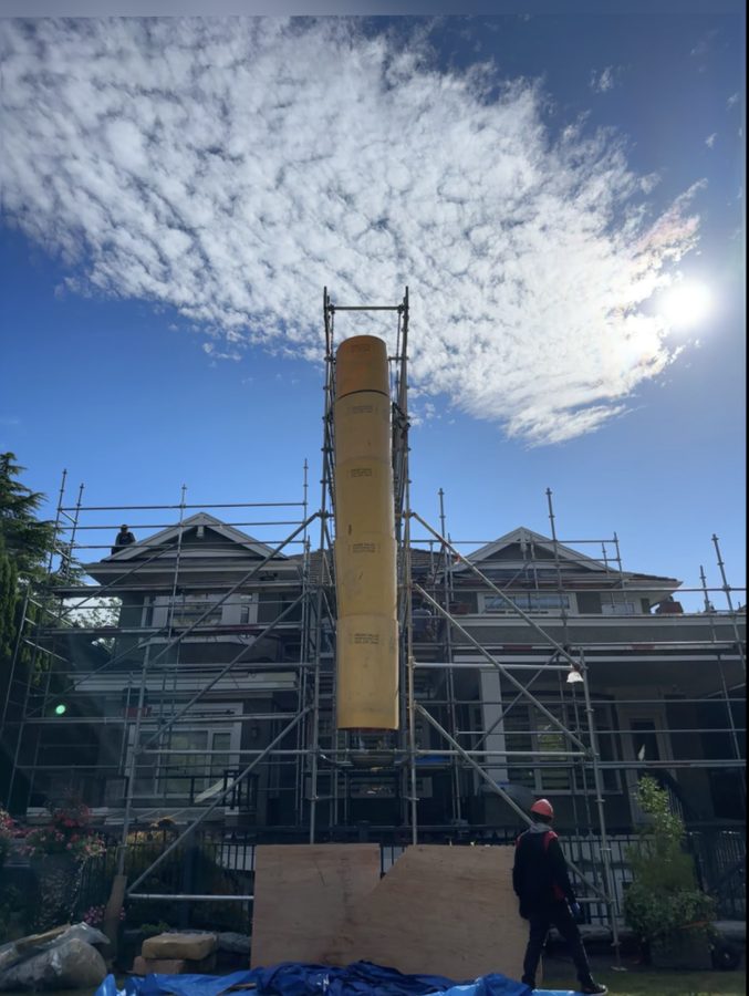 Yellow debris chute installed on scaffold